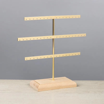 porte boucle d'oreille métal couleur or.